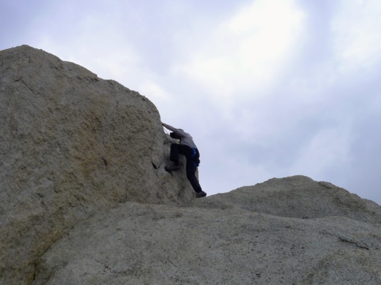 Kurt climbs the summit block. Photo credit: Craig the hermit