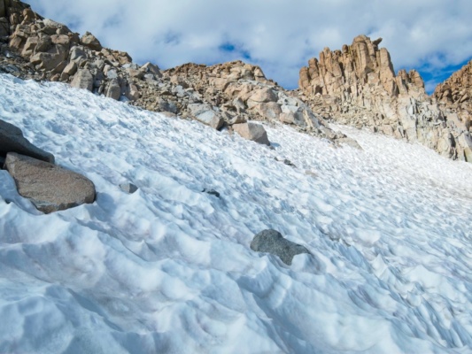We hike up a bit of snow to reach the col lamarck col