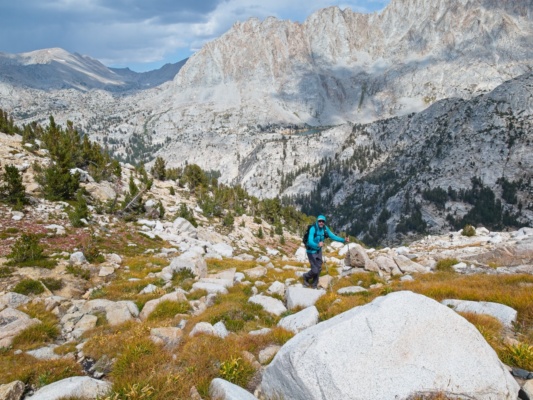 Craig hikes up east slope of The Hermit with Evolution Lake and Darwin Canyon in the background the hermit