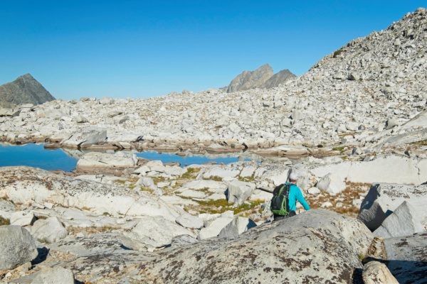 Craig hikes past a small pond on Davis Lakes Pass davis lake pass