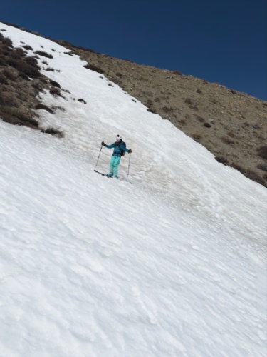 A thin tongue of snow allows us to reach the bottom of the gully without taking our skis off kid mountain ski tour