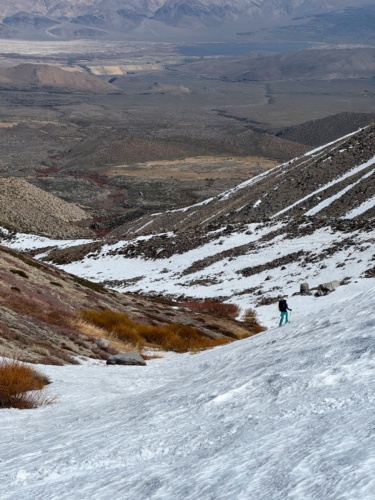 We follow the snow as low as we can, back to where we stashed our shoes kid mountain ski tour