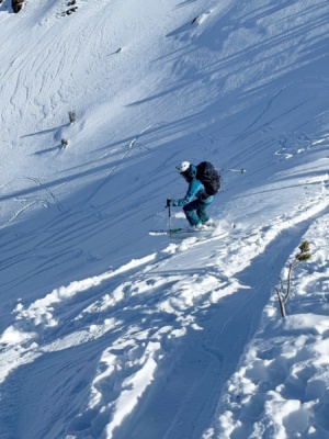 Maddie leaps down the slope red cone