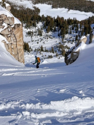 I struggle my way down the chute on sticky skis red cone