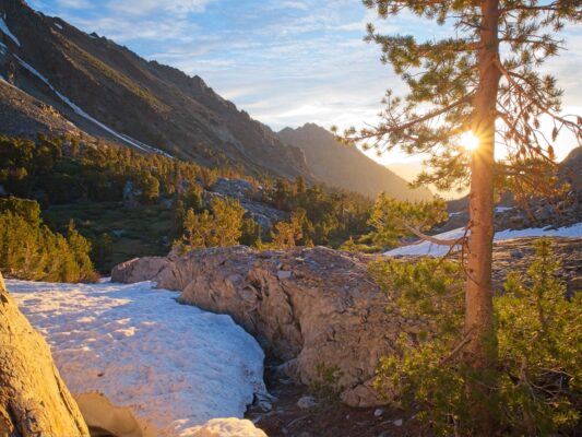 The sun peaks over the White Mountains black diamond traverse