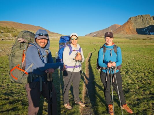 CK, Kenza, and Shannon squint into the sunset; Parker Pass isn't far now parker pass trail