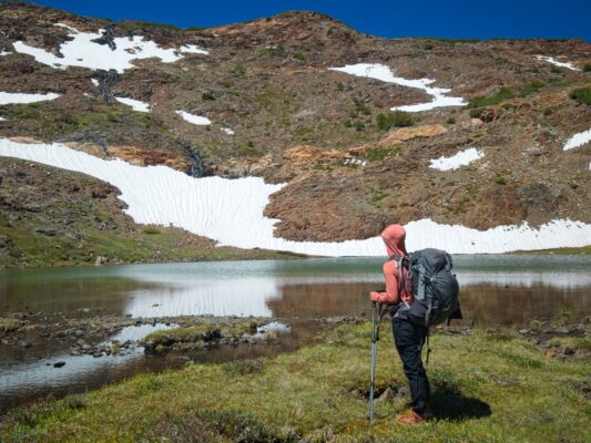 Shannon admires a lake before we start the long section of switchbacks alpine lake