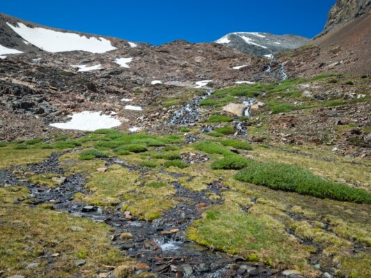 Cascades of snowmelt running through the rocks alpine cascades