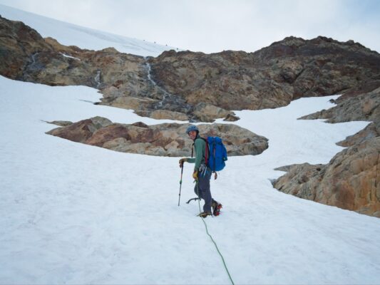 Josh leads the rope team; you can see another team of five high on the ridge above mountaineering