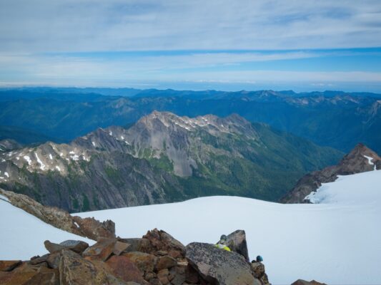 The clouds begin to break up and sunlight catches the mountains mount olympus