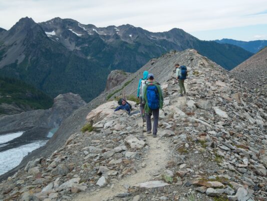 A day hiker atop the moraine asks about the climb to Mount Olympus mount olympus