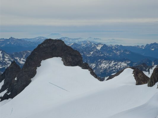 Mount Rainier pokes into the clouds in the distance mount rainier