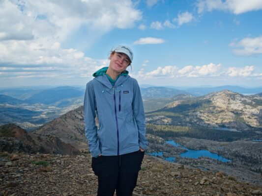 Shannon poses in front of the lakes dicks peak