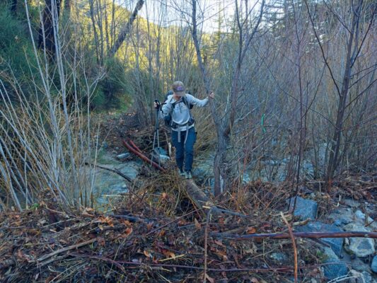 Shannon crosses the West Fork of the San Gabriel River via a log gabrielino trail