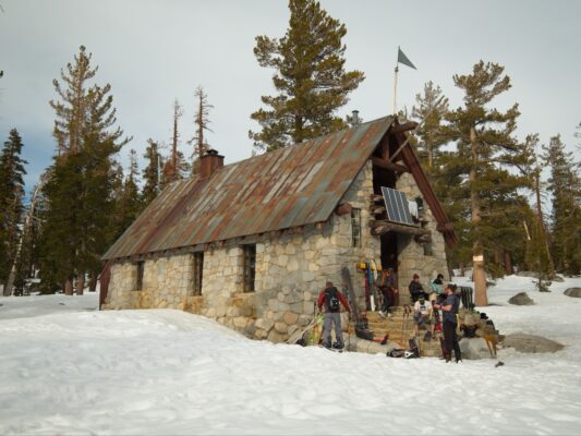 Our fellow skiers lounge on the porch in the warm afternoon sun ostrander ski hut