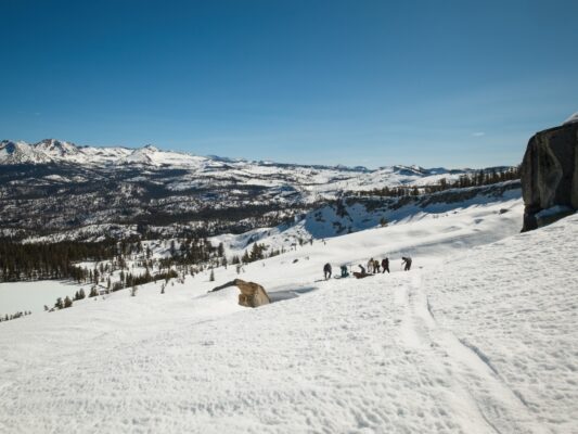 A group of riders transition out of their skins on the ridge above Hart Lakes ostrander ski hut