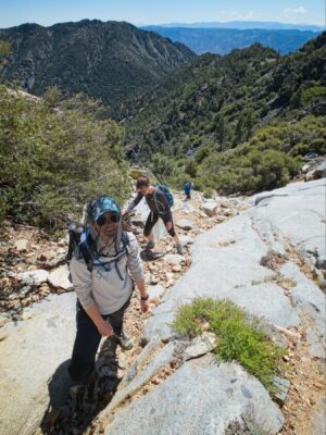 Shannon, Jordan, and Jenna scramble up the steep granite slabs owens peak